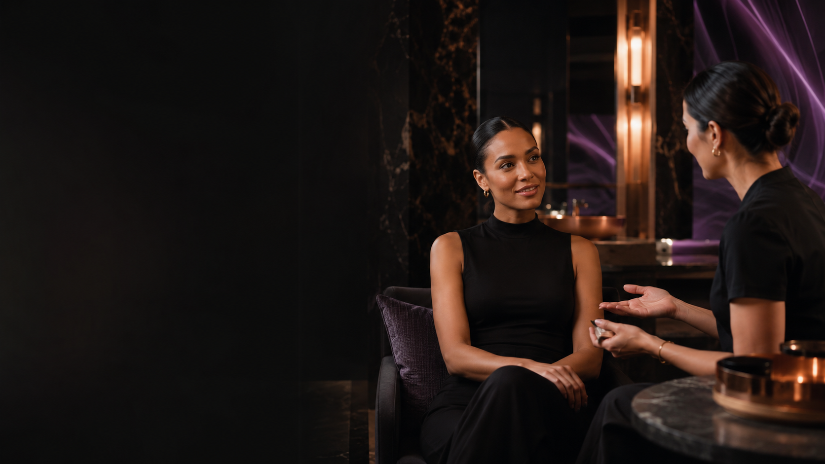 Beauty professional consulting with a client in a sophisticated modern wellness studio